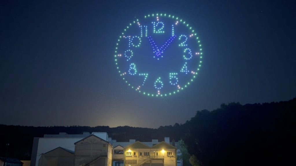 Horloge géante réalisée dans le ciel par 300 drones lumineux lors du spectacle des 100 ans d’Évole Énergie à Besançon.